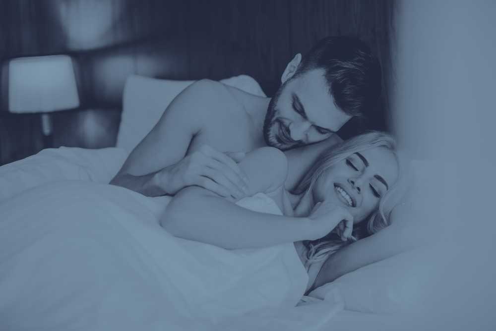 Casal se acariciando na cama